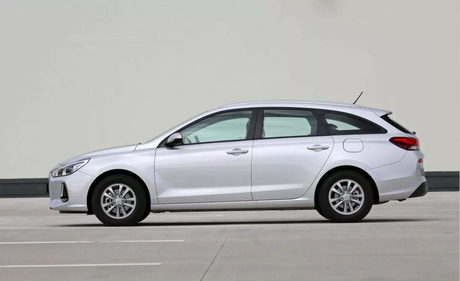 Profilowy widok kompaktowego hatchbacka Hyundai i30-N z 2017 roku ukazujący eleganckie reflektory LED, kierunkowskazy zintegrowane w lusterkach bocznych, aerodynamiczne linie, felgi z lekkich stopów, długi rozstaw osi zapewniający większy komfort oraz potencjalny napęd hybrydowy lub elektryczny wskazany brakiem widocznych rur wydechowych, w profesjonalnym otoczeniu fotograficznym