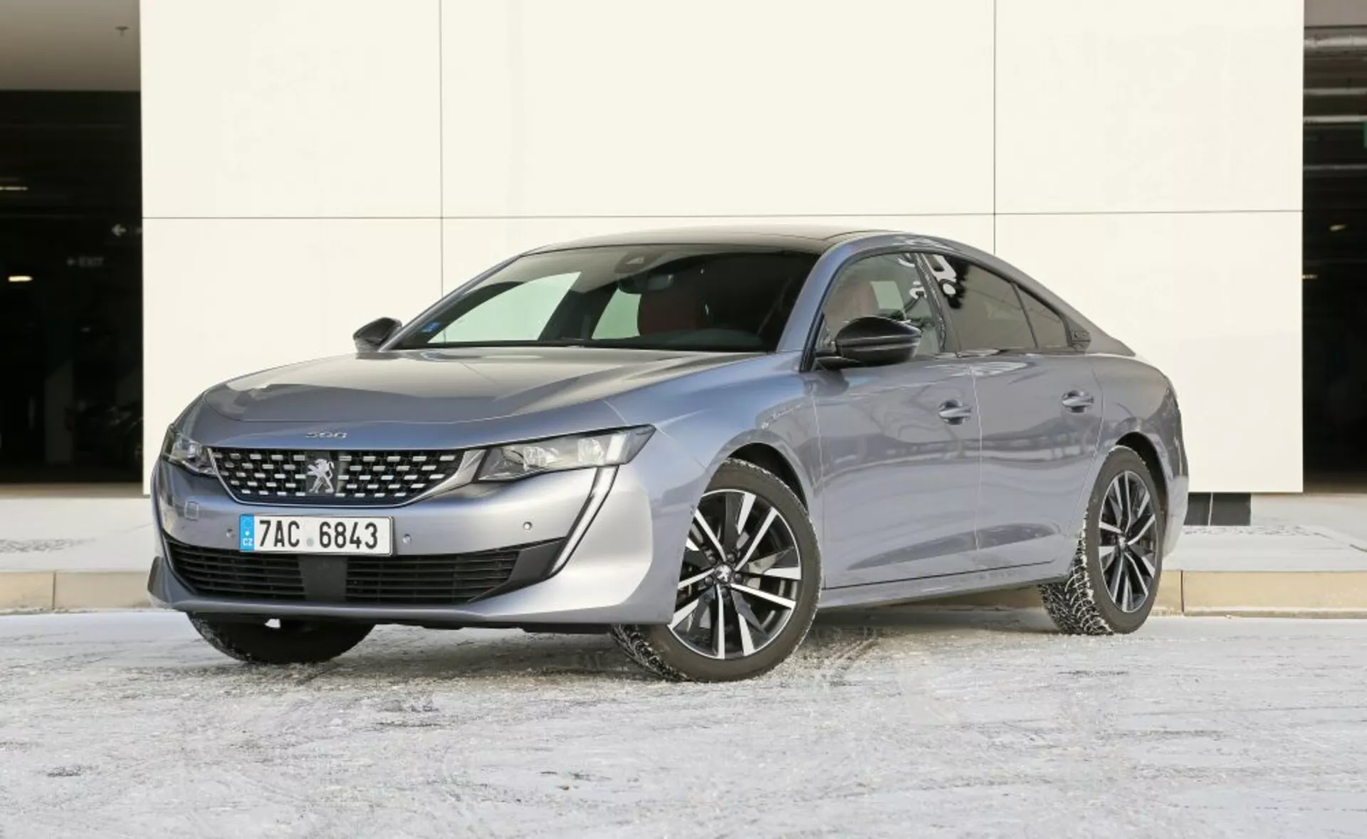 Sedan Mazda 6 z 2013 roku zaparkowany na zewnątrz z lekkim pokryciem śniegu, prezentujący elegancki design i nowoczesne funkcje, takie jak reflektory LED i chromowane akcenty