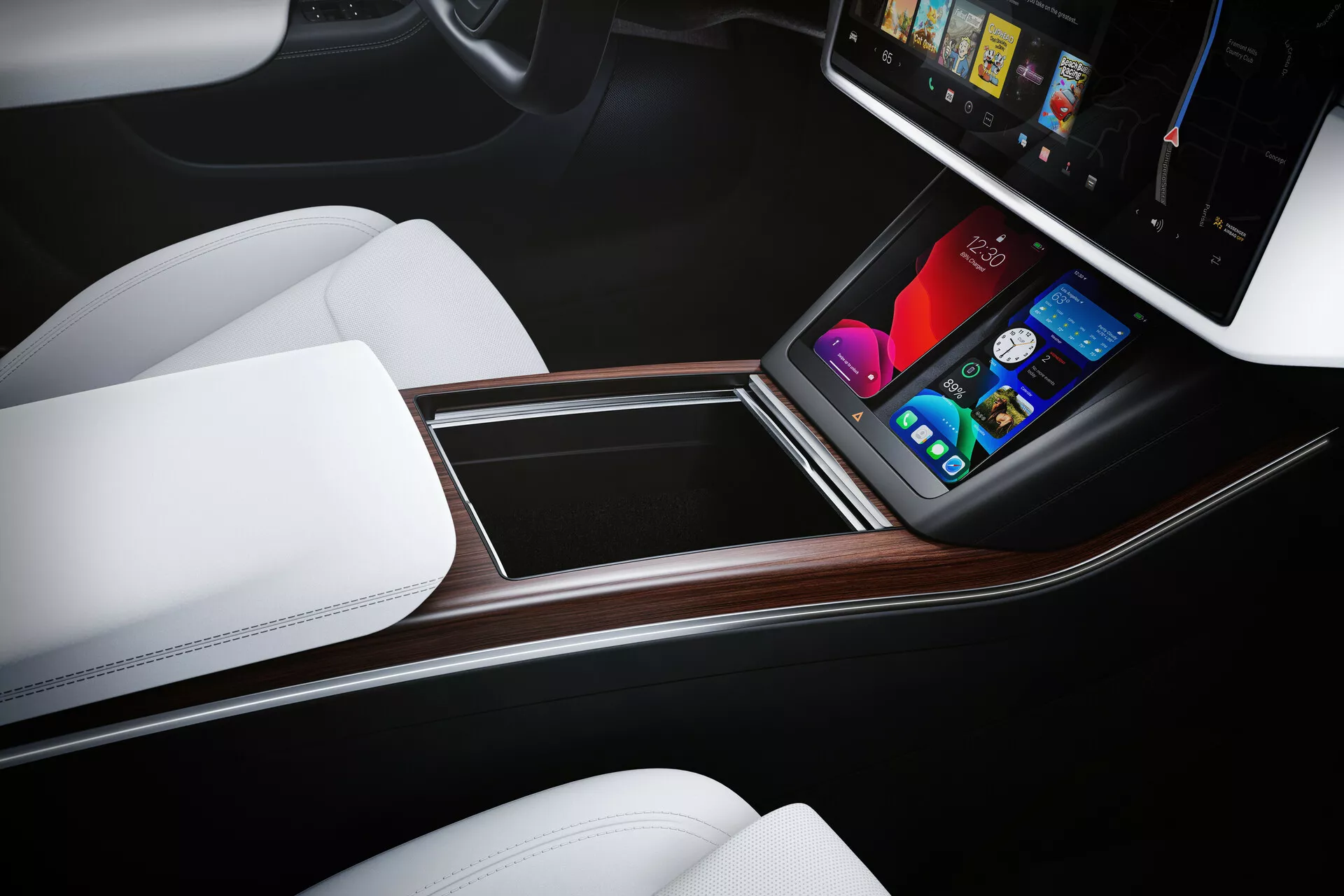 Widok wnętrza Tesla Model S 2016 (1. generacja, lifting) z naciskiem na konsolę centralną z perspektywy z góry, ukierunkowanej na kierowcę. Ergonomiczny układ wyposażony w pionowy ekran dotykowy systemu rozrywki, wyświetlający kolorowe grafiki do sterowania klimatem, mediami, nawigacją i ustawieniami pojazdu. Konsola wykończona jest materiałem przypominającym drewno, białymi fotelami o wykończeniu przypominającym skórę i dwukolorowym wzornictwem, podkreślając luksus i minimalną ilość fizycznych przycisków.