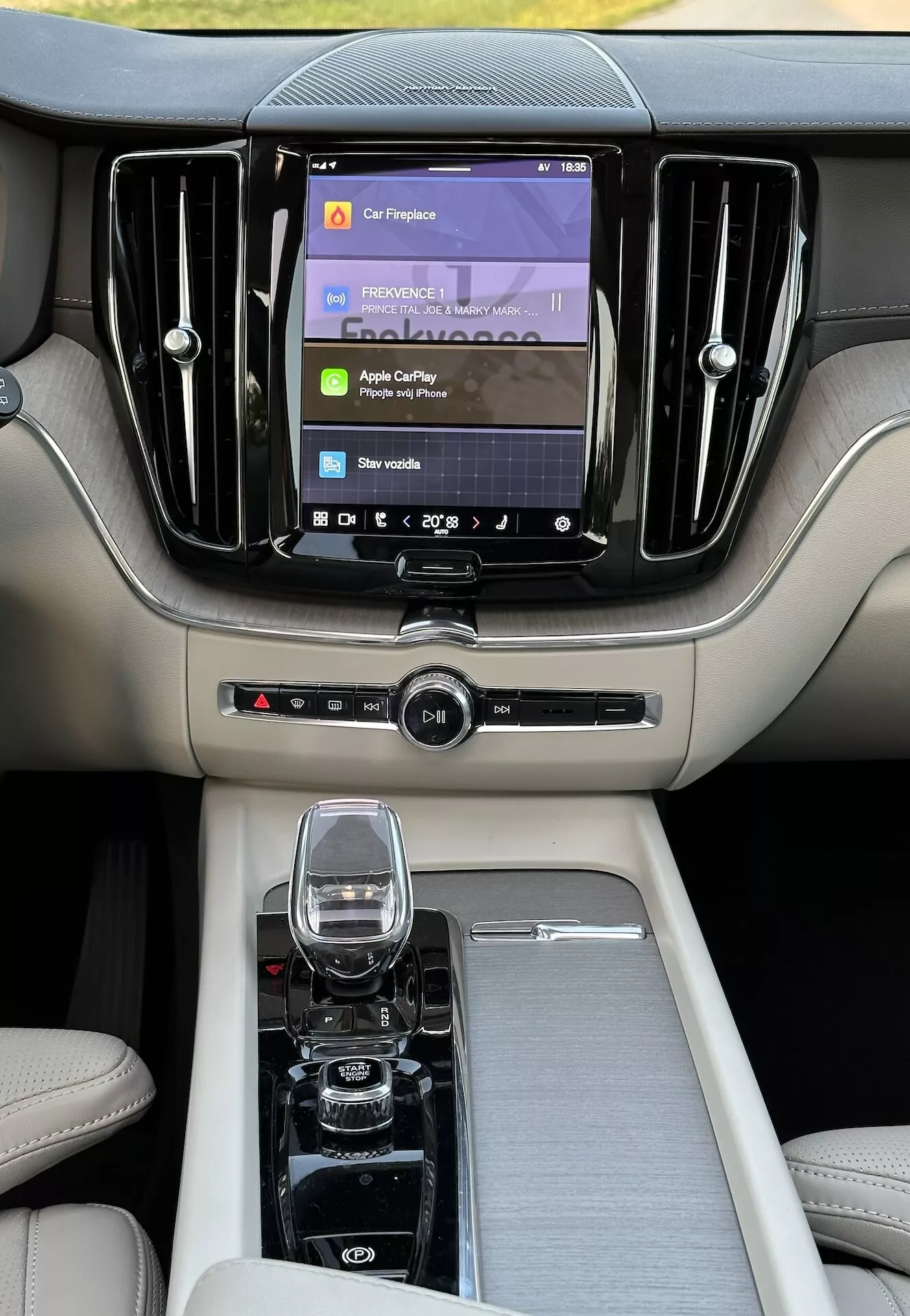 Wnętrze Volvo XC60 Recharge Plug-in Hybrid 2021 ze skupieniem na luksusową konsolę środkową i deske rozdzielczą z nowoczesnym systemem infotainment i wysokiej jakości materiałami z perspektywy tylnego siedzenia