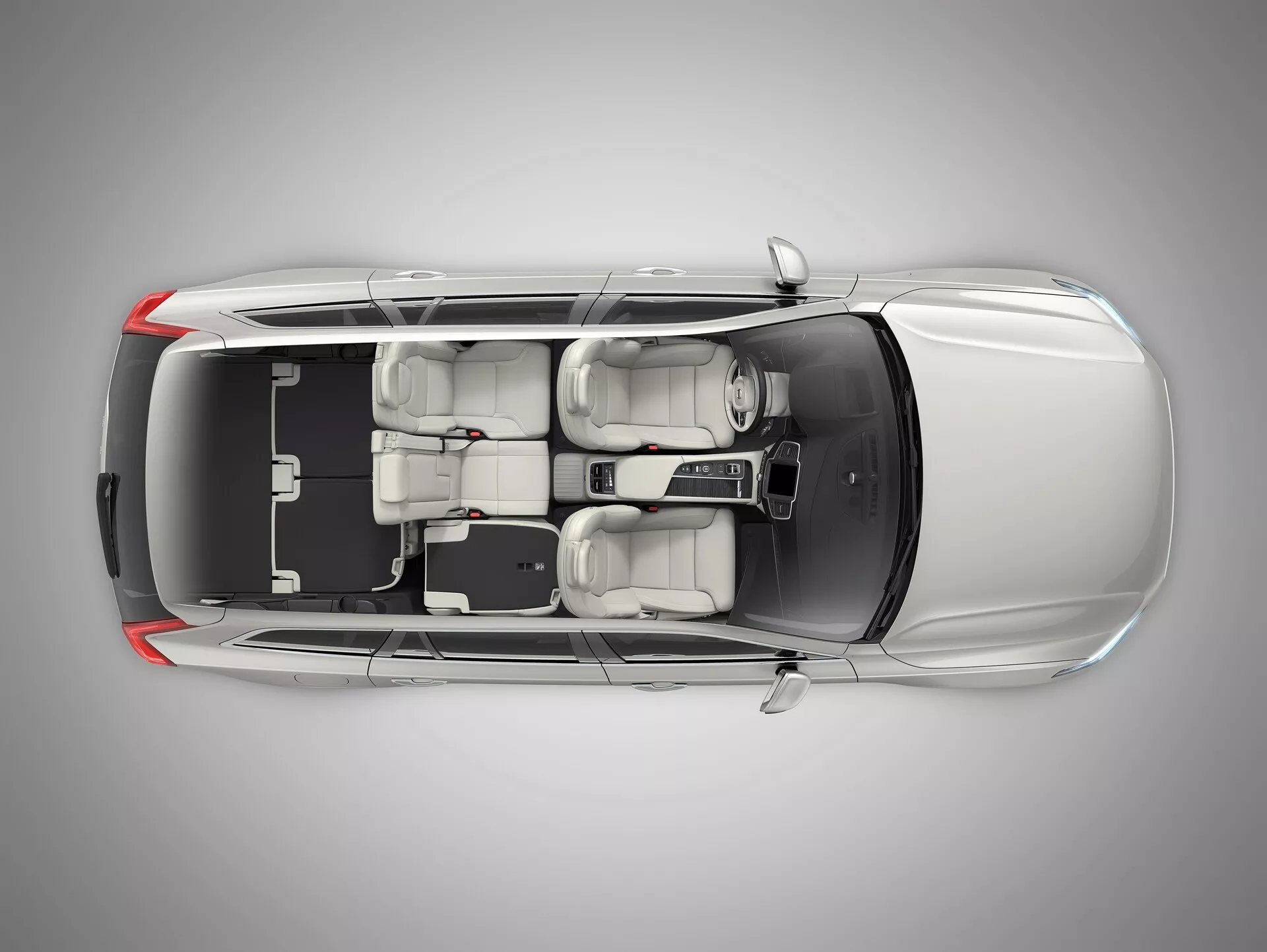Widok z góry na Volvo XC90 2015 (2. generacja), pokazujący jego dach, maskę, bagażnik i okna. Funkcje obejmują centralnie umieszczony szyberdach, obrysowane okna oraz elegancką linię dachu sugerującą aerodynamiczną wydajność. Sylwetka pojazdu ukazuje czterodrzwiowego sedana z dwurzędowym układem siedzeń, mieszczącego do pięciu pasażerów.