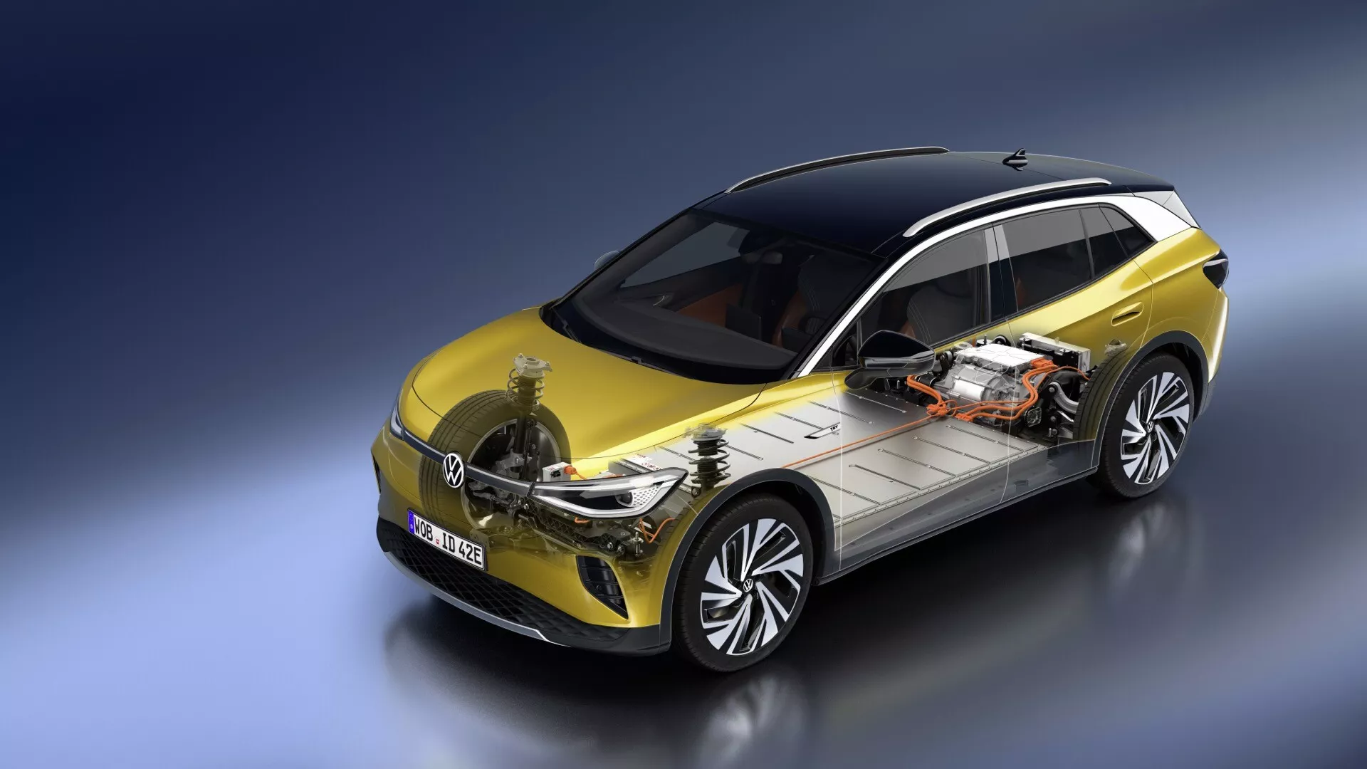 VW ID.4 2020 1. generacji prezentujący podwójny widok eleganckiej zewnętrznej strony w kolorze żółtym z czarnym dachem i częściowo odsłonięty napęd elektryczny w tym pakiet baterii i silnik