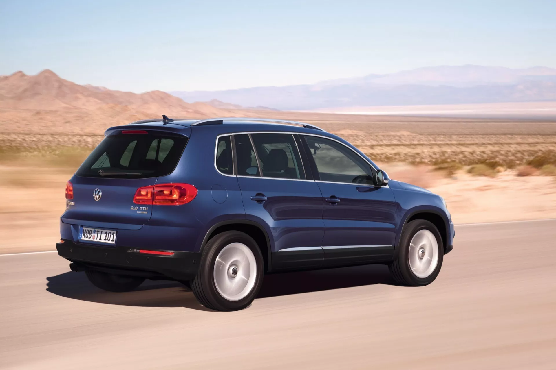 VW Tiguan 2007 w ruchu, prezentujący jego nowoczesny design SUV z widokiem z tyłu pod kątem trzech czwartych, podkreślający boczny profil pojazdu, tylny design, światła LED oraz funkcje technologiczne